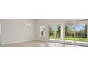Open-concept living room with sliding glass doors leading to the patio and backyard at 3458 Yellow Leaf Cir, Spring Hill, FL 34609