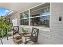 Covered front porch with outdoor seating and plants at 4922 Bola St, New Port Richey, FL 34652
