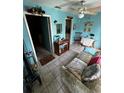 Bright living room with tile floors, ceiling fan, and comfortable seating area at 5247 81St N St # 2, St Petersburg, FL 33709