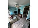 Comfortable living room featuring tile floors, ceiling fan, and access to kitchen and hallway at 5247 81St N St # 2, St Petersburg, FL 33709