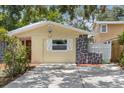Exterior showcasing the house number and gray stone accents near the driveway at 5611 Burlington N Ave, St Petersburg, FL 33710