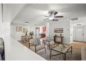 Sunlit living room with open concept, hardwood flooring, and a view of the kitchen at 8499 101St Ave, Seminole, FL 33777