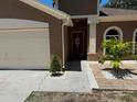Inviting home exterior with a well-manicured garden and a classic front door at 904 Grand Canyon Dr, Valrico, FL 33594