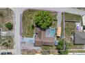 Aerial view of the property highlighting its .40 acre lot featuring a pool, shed, and driveway at 9642 Elgin Blvd, Spring Hill, FL 34606