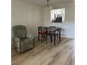 Open dining area with wood-look floors, adjacent to the kitchen and living space at 13829 Mission Oaks Blvd, Seminole, FL 33776