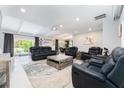 Spacious living room with comfortable seating, stylish decor, and natural light from sliding glass doors at 120 Crestwood Ln, Largo, FL 33770