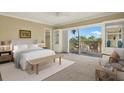 Bright bedroom featuring light-colored furniture, carpet, built-ins and sliding doors to a balcony at 1200 N Shore Ne Dr # 404, St Petersburg, FL 33701