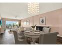 Bright dining room featuring a chandelier, seating for four, and sliding doors to a balcony at 1200 N Shore Ne Dr # 404, St Petersburg, FL 33701