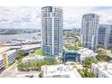 Aerial view of white high-rise towers with private balconies and a beautiful pool and manicured grounds at 1209 E Cumberland Ave # 1003, Tampa, FL 33602