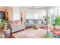 Bright living room featuring cozy seating, plants, and a large window with natural light at 1209 E Cumberland Ave # 1003, Tampa, FL 33602