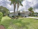 Inviting single-Gathering home featuring a manicured lawn and mature trees at 1338 Winding Willow Dr, Trinity, FL 34655