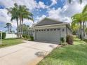 Well-maintained home with a large two-car garage and a neatly landscaped yard at 1338 Winding Willow Dr, Trinity, FL 34655