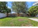 Expansive backyard featuring a large lawn area and a wooden fence, providing privacy and ample space at 1420 Temple St, Clearwater, FL 33756