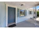 Inviting covered porch with a stylish front door, matching shutters, and space for outdoor seating at 1420 Temple St, Clearwater, FL 33756