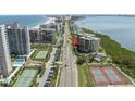 Enjoy stunning aerial view of condo, tennis courts, and beachfront location; paradise found at 1501 Gulf Blvd # 201, Clearwater Beach, FL 33767