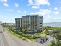 Exterior showcases lush tropical landscaping and palm trees with ocean views, creating an inviting atmosphere at 1501 Gulf Blvd # 201, Clearwater Beach, FL 33767