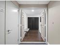 Hallway featuring hardwood floors, seating, and closet space, creating an organized and stylish transition at 1501 Gulf Blvd # 201, Clearwater Beach, FL 33767
