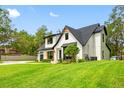 Charming two-story home with a modern farmhouse style, well-manicured lawn, and inviting curb appeal at 18202 Abbey Ln, Lutz, FL 33548