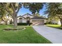 Charming single-Gathering home with a well-maintained lawn, mature trees, and a two-car garage at 2043 Wrangler Dr, Brandon, FL 33511