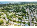 Aerial view showcases the home's location within a lush, green neighborhood with a glimpse of the bay at 2481 12Th Sw Ave, Largo, FL 33770