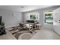 Bright living room featuring a large window, light wood floors, and a comfortable sectional sofa at 2481 12Th Sw Ave, Largo, FL 33770
