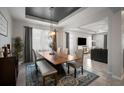 Elegant dining room featuring a modern chandelier, a large wooden table, and an area rug at 2513 Knight Island Dr, Brandon, FL 33511