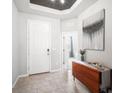 Inviting entryway with tile flooring, a stylish console table, and a white front door at 2513 Knight Island Dr, Brandon, FL 33511