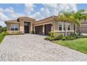 Lovely home with paver driveway, manicured lawn, and attached two car garage at 3197 Acacia Bay Ave, Wesley Chapel, FL 33543