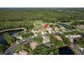 Wide aerial of the houses in the neighborhood with community ponds and mature trees at 3337 Crescent Oaks Blvd, Tarpon Springs, FL 34688