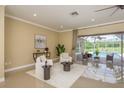 Bright living room with seating area that overlooks the pool at 3337 Crescent Oaks Blvd, Tarpon Springs, FL 34688