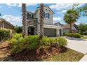 Inviting two-story home with lush landscaping and a stone-accented entryway at 3532 Wicket Field Rd, Lutz, FL 33548