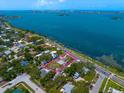 Aerial view shows property lines with waterfront access and lush, mature landscaping at 43 Edgewater Dr, Dunedin, FL 34698
