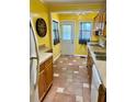 Cozy kitchen with warm yellow walls, tile floors, wood cabinets and modern appliances at 4634 Iris N St, St Petersburg, FL 33714