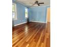 Inviting living room featuring gleaming hardwood floors, light blue walls, and ample natural light at 4634 Iris N St, St Petersburg, FL 33714