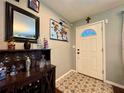 Inviting entryway with decorative tile flooring, a stylish bar cabinet, and a well-lit white front door at 4901 Taylor N St, St Petersburg, FL 33714