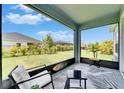 Relaxing screened-in patio featuring a comfortable chair and a view of the fenced backyard at 5415 Limelight Dr, Apollo Beach, FL 33572