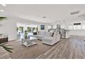 Open-concept living room with views of the kitchen and pool area, perfect for entertaining at 5473 Bayshore Dr, Seminole, FL 33772