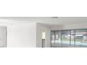 Open living room area with access to the pool through sliding glass doors and a glimpse of the kitchen at 6236 17Th S St, St Petersburg, FL 33712