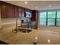 Updated kitchen features granite counters, stainless appliances, and ample cabinet space at 7821 Niagara Ave # 2102, Tampa, FL 33617