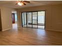 Bright living room showing sliding glass doors to enclosed patio at 7821 Niagara Ave # 2102, Tampa, FL 33617