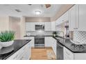 Stylish kitchen featuring white cabinets, granite countertops, stainless steel appliances, and a tiled backsplash at 8501 56Th N St, Pinellas Park, FL 33781