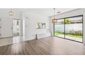 Bright dining room with sliding glass doors and views of the outdoor area at 8645 Piper Ln, Seminole, FL 33777