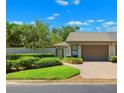 Well-maintained home with updated landscaping and a brick driveway leading to the garage at 8645 Piper Ln, Seminole, FL 33777