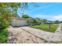 Charming single-story home with attached garage and mature landscaping along long driveway at 10125 Cherry Creek Ln, Port Richey, FL 34668