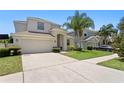 Lovely home with a well-maintained lawn, mature trees, and a spacious driveway at 10216 Summer Azure Dr, Riverview, FL 33578