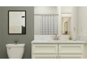 Cozy bathroom features a framed painting, marble counter top with white cabinets, and shower behind a curtain at 10857 Rustic Eve Ct, Land O Lakes, FL 34638