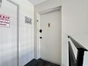 Hallway featuring a white door and dark trim at 1125 83Rd N Ave # D, St Petersburg, FL 33702