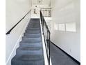Carpeted staircase with black iron railings, leading to the upper level at 1125 83Rd N Ave # D, St Petersburg, FL 33702