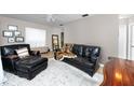 Cozy living room featuring comfortable seating, neutral walls, and a plush white rug for a welcoming atmosphere at 12400 Park Blvd # 417, Seminole, FL 33772