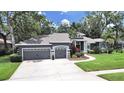 Lovely home with a large manicured front lawn, attached garage, and a picturesque entrance at 15024 Eaglepark Pl, Lithia, FL 33547